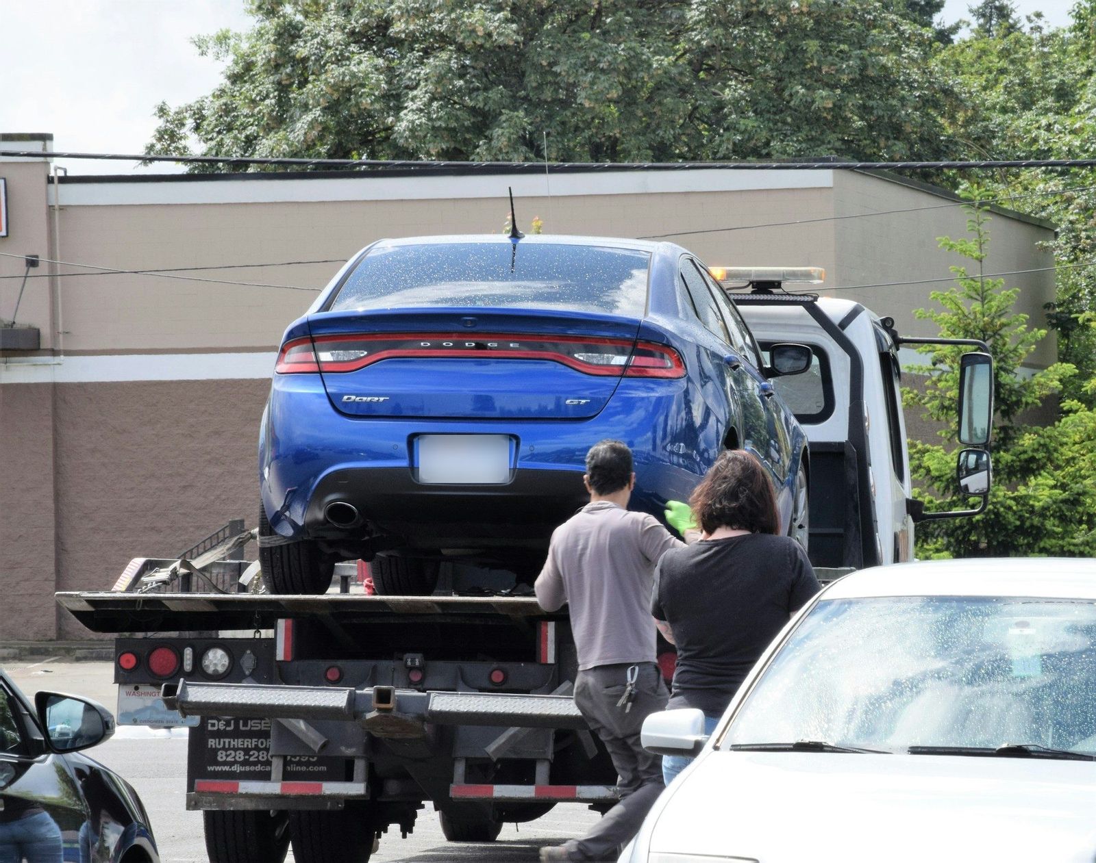 Flatbed tow truck loading a car